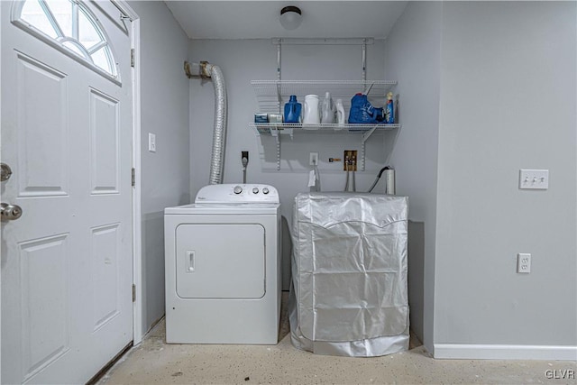 laundry room featuring laundry area, baseboards, and washer and clothes dryer