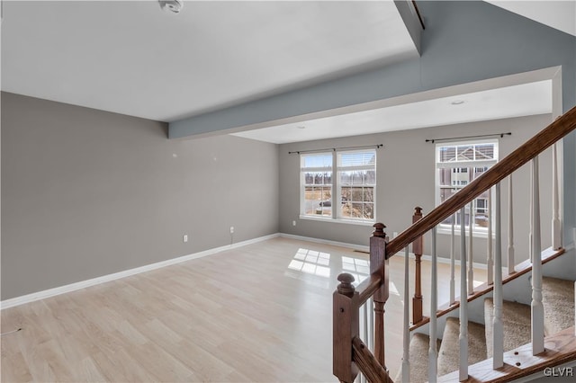 interior space featuring light wood-style floors, stairway, and baseboards