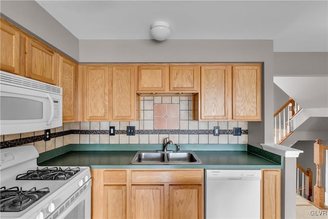 kitchen featuring white appliances, dark countertops, a sink, light brown cabinetry, and backsplash