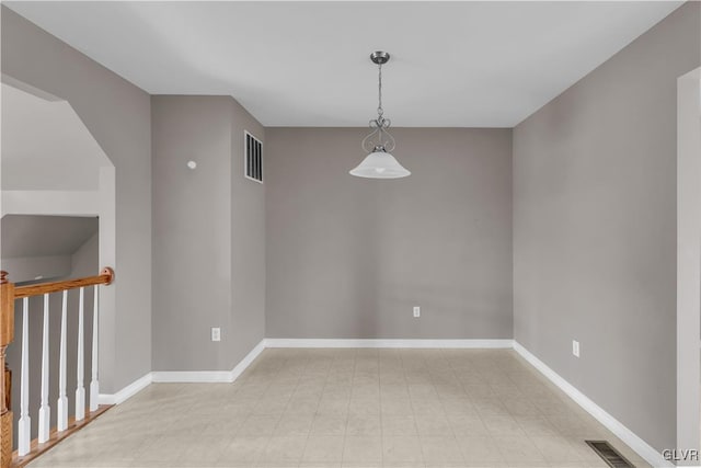 unfurnished room with visible vents and baseboards