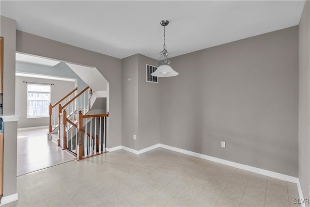 spare room with light floors, baseboards, stairs, and visible vents