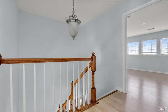 interior space with wood finished floors, visible vents, and baseboards