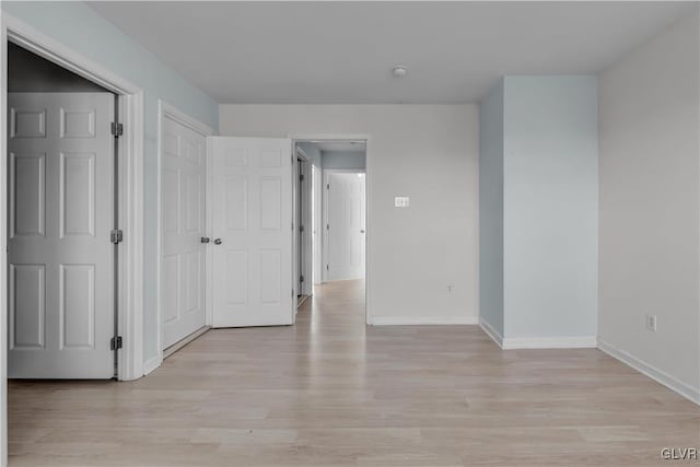 unfurnished room featuring light wood-style floors and baseboards