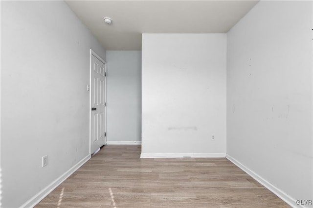 spare room featuring light wood-style flooring and baseboards