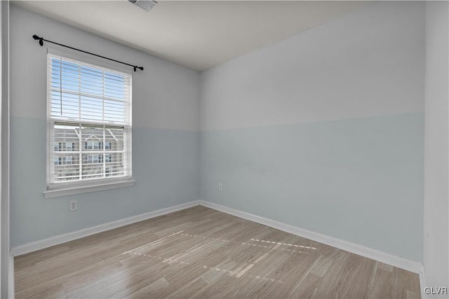 unfurnished room featuring light wood finished floors and baseboards