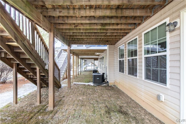 view of patio with cooling unit and stairs