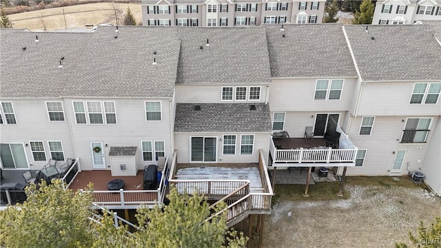 rear view of house with a deck and central AC