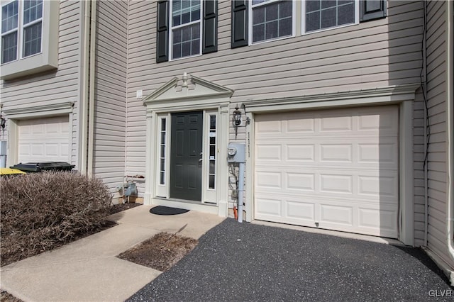 doorway to property featuring an attached garage