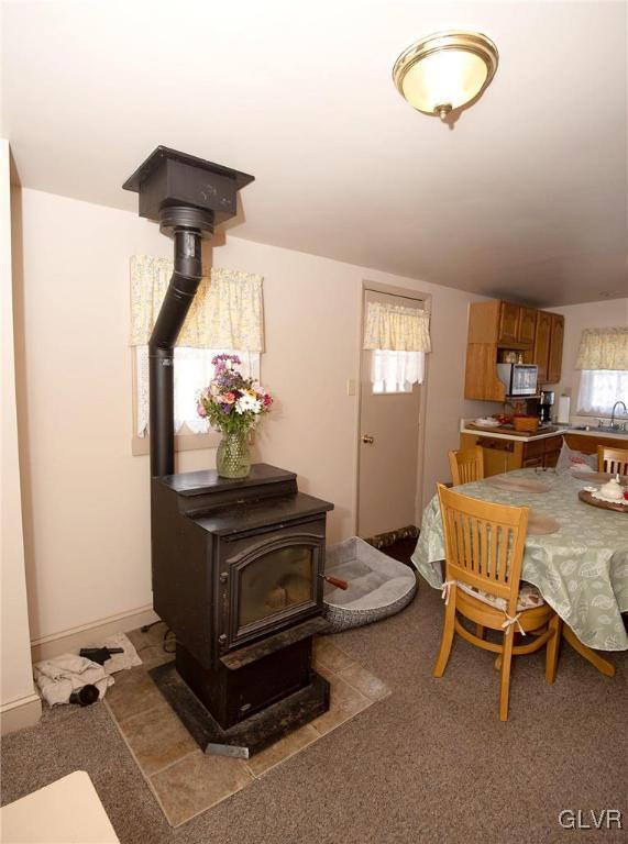 dining room with a wood stove and baseboards