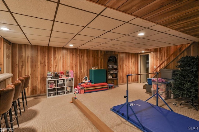 exercise area with carpet, wooden walls, and recessed lighting