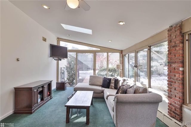 living room featuring lofted ceiling with skylight, a wealth of natural light, visible vents, and baseboard heating