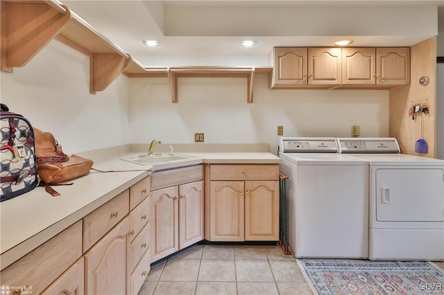 washroom with cabinet space, light tile patterned flooring, separate washer and dryer, a sink, and recessed lighting