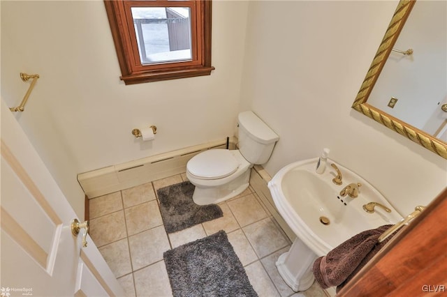 half bath featuring tile patterned flooring and toilet