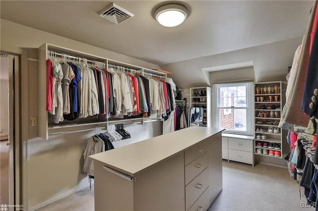 walk in closet featuring light carpet and visible vents