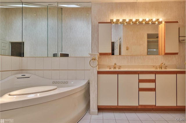 bathroom featuring tile patterned floors, a garden tub, a sink, and double vanity