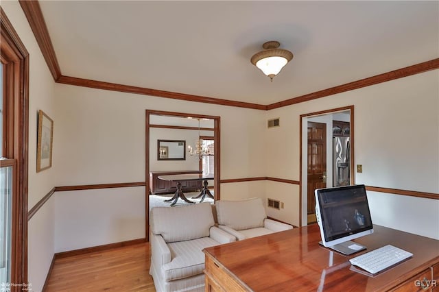 office featuring baseboards, light wood-style flooring, visible vents, and crown molding