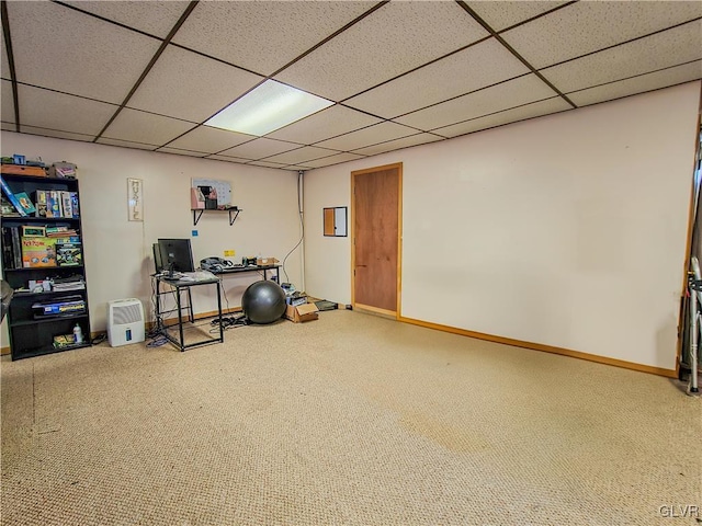 below grade area featuring a drop ceiling and baseboards