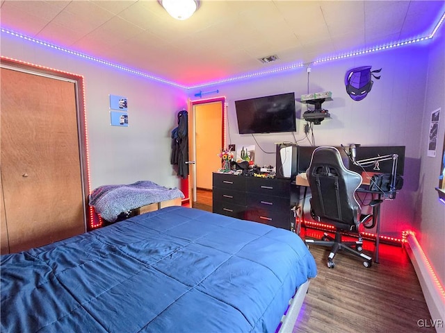 bedroom with visible vents and wood finished floors