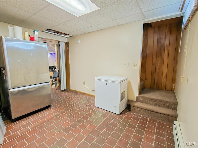 kitchen featuring a paneled ceiling, visible vents, baseboard heating, fridge, and freestanding refrigerator