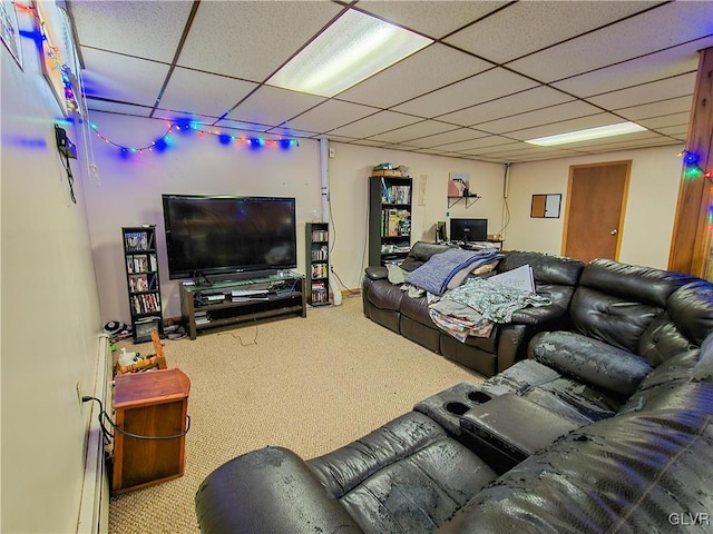 living area featuring carpet floors and a paneled ceiling