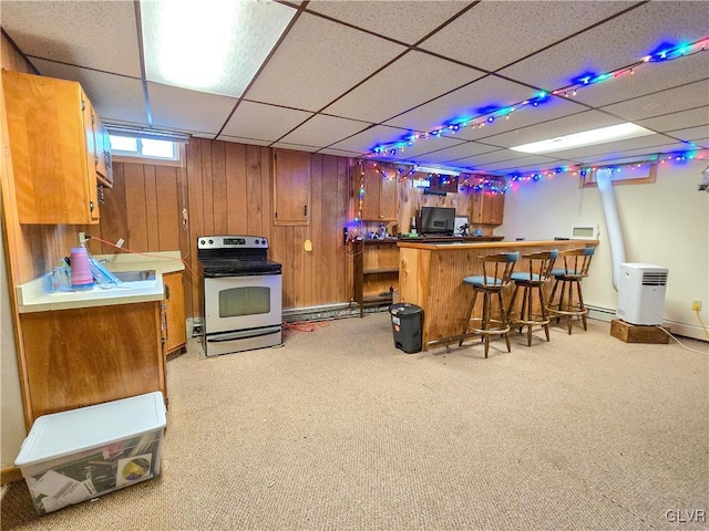 bar with a bar, stainless steel electric stove, a drop ceiling, and light colored carpet