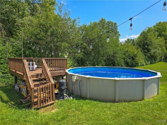 outdoor pool featuring a wooden deck and a yard