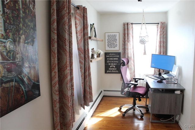 office space featuring baseboard heating and wood finished floors