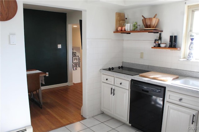 kitchen with light tile patterned floors, open shelves, white cabinetry, a sink, and black appliances