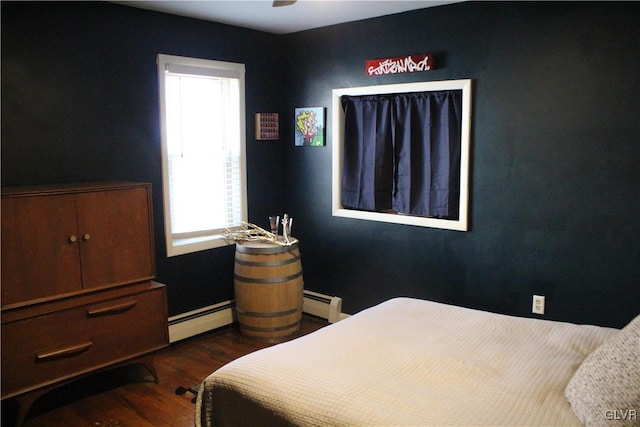 bedroom featuring dark wood-style floors and a baseboard heating unit