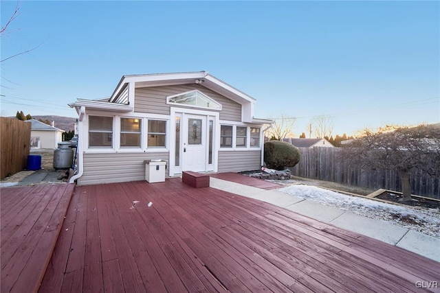 exterior space featuring fence and a sunroom