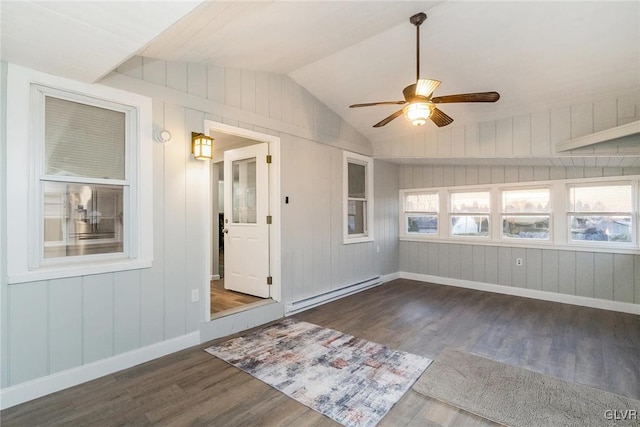 unfurnished sunroom with a baseboard heating unit, vaulted ceiling, and a ceiling fan