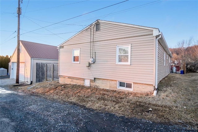 view of side of property with a detached garage