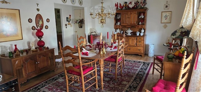 dining room featuring dark wood-style flooring and an inviting chandelier