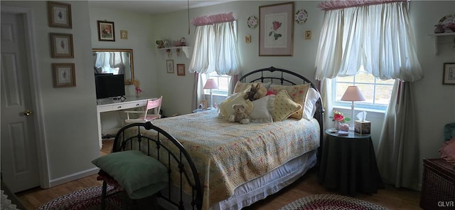 bedroom with wood finished floors