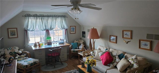 interior space with a ceiling fan, vaulted ceiling, and wood finished floors