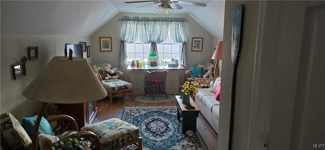 living area with vaulted ceiling, a ceiling fan, and wood finished floors