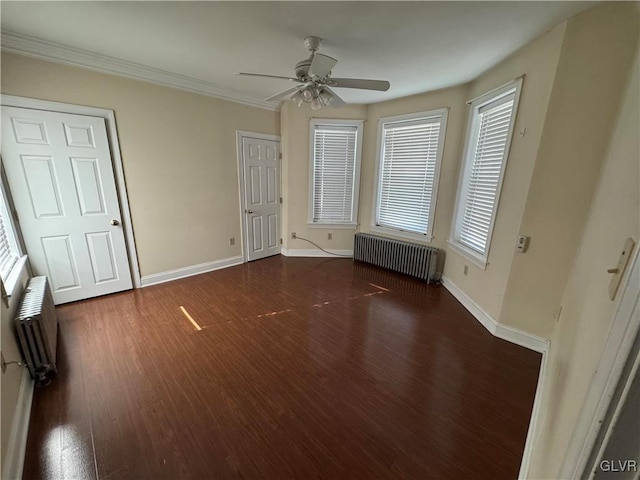 unfurnished bedroom featuring baseboards, radiator, wood finished floors, and crown molding