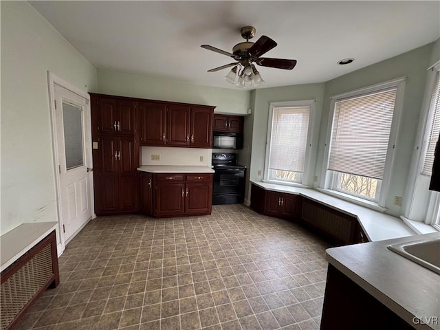 kitchen with black appliances, a ceiling fan, and light countertops