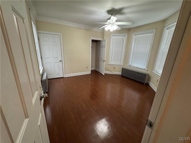 unfurnished bedroom featuring dark wood-style floors, radiator, baseboards, and ornamental molding