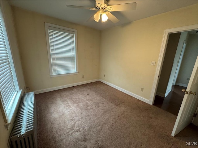 unfurnished bedroom featuring multiple windows, ceiling fan, baseboards, and carpet floors