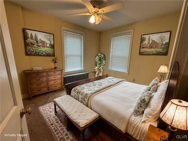 carpeted bedroom featuring radiator heating unit and ceiling fan