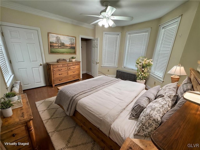 bedroom featuring ornamental molding, a ceiling fan, and wood finished floors