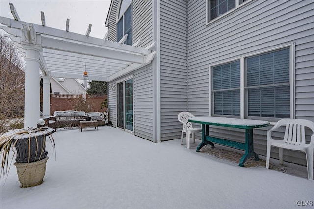 snow covered patio featuring fence and a pergola