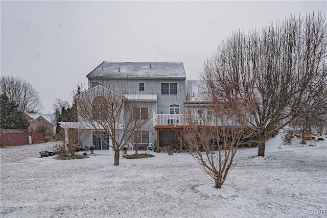 view of snow covered rear of property