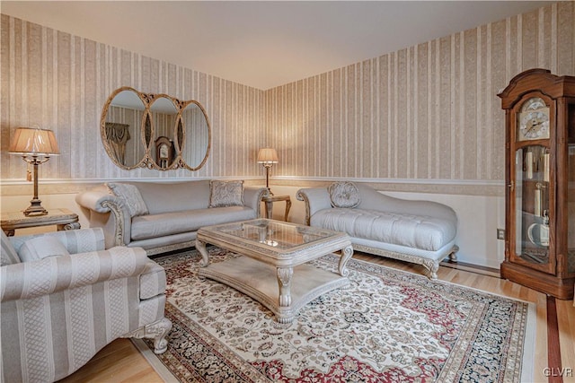 living room with light wood-type flooring and wallpapered walls