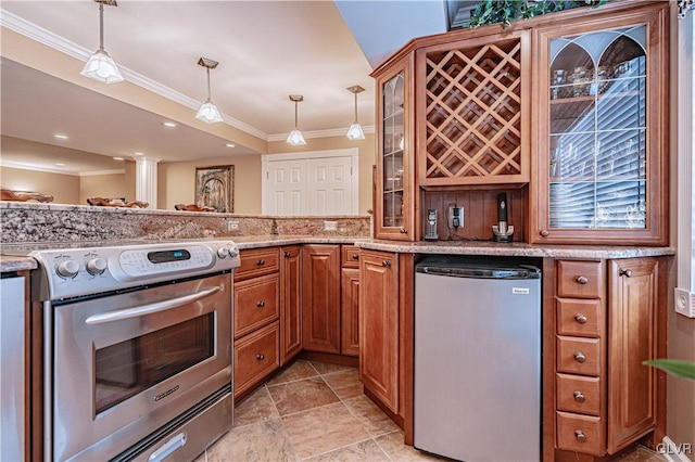 kitchen featuring appliances with stainless steel finishes, brown cabinetry, glass insert cabinets, and pendant lighting