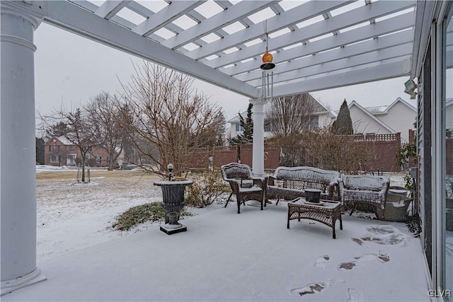 snow covered patio featuring outdoor lounge area, fence, and a pergola