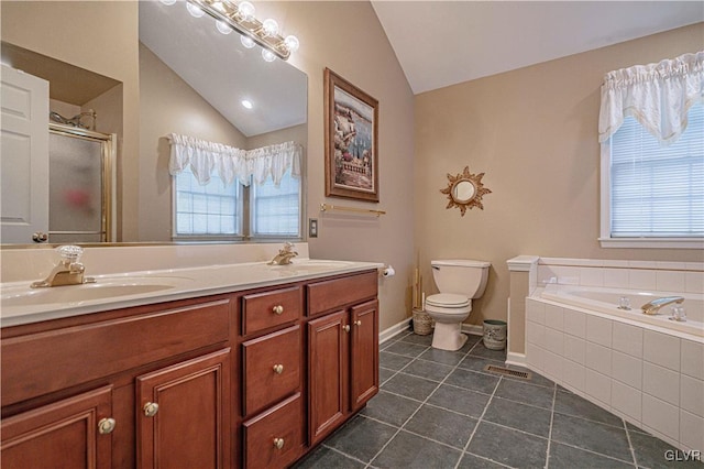 bathroom with lofted ceiling, a garden tub, and a sink