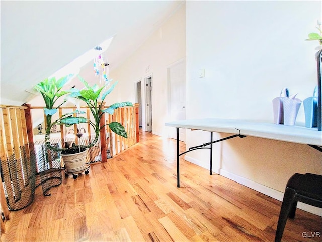 playroom with vaulted ceiling, wood finished floors, and baseboards