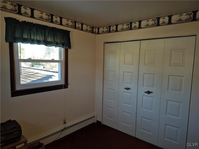 unfurnished bedroom featuring a baseboard radiator and a closet